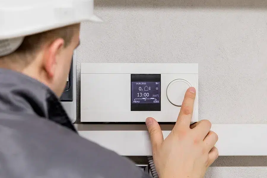 Technician repairing thermostat