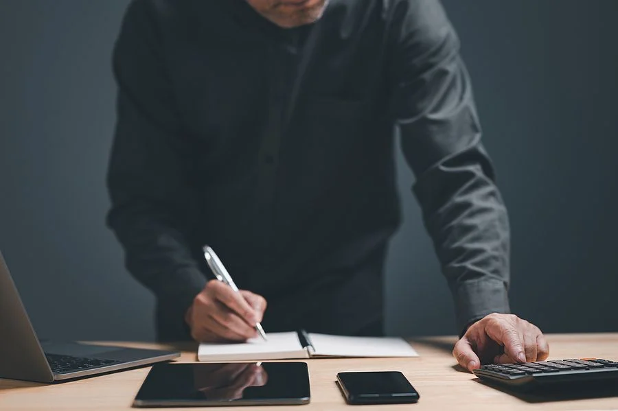 Person writing on notepad