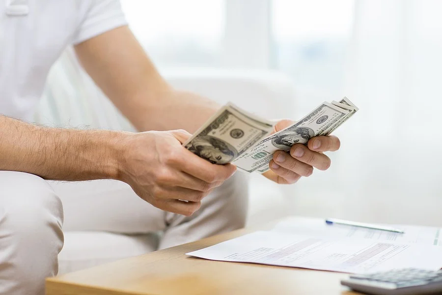 Person holding money in their hand