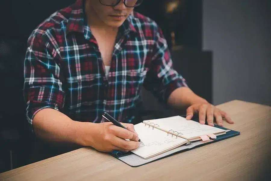 Man writing in planner