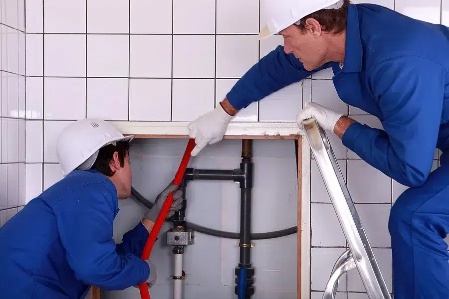 Technicians working on plumbing